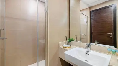a bathroom with a sink and a shower at Sparkle Tower by Swarovski, Premium Full Marina View, 2min JBR & Metro, Sleeps 4 in Dubai