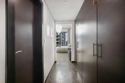 a hallway with two elevators and a living room at Sparkle Tower by Swarovski, Premium Full Marina View, 2min JBR & Metro, Sleeps 4 in Dubai
