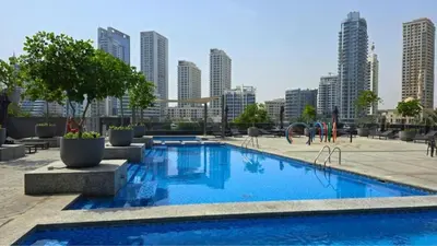 a large swimming pool in a city with tall buildings at Sparkle Tower by Swarovski, Premium Full Marina View, 2min JBR & Metro, Sleeps 4 in Dubai