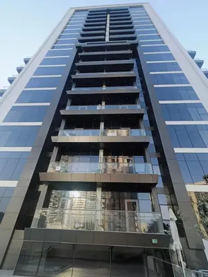 a tall building with a lot of windows at Fully furnished studio with amenities in Dubai in Dubai