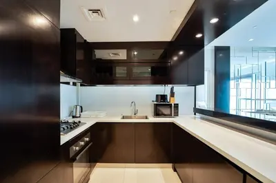 a kitchen with a sink and a counter top at Refined 1 bedroom - Upper Crest - Near Dubai Mall in Dubai