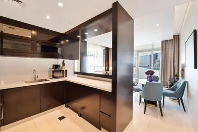 a kitchen and dining room with a table and chairs at Refined 1 bedroom - Upper Crest - Near Dubai Mall in Dubai