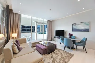 a living room with a couch and a table at Refined 1 bedroom - Upper Crest - Near Dubai Mall in Dubai