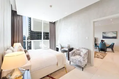 a bedroom with a bed and a desk and a chair at Refined 1 bedroom - Upper Crest - Near Dubai Mall in Dubai