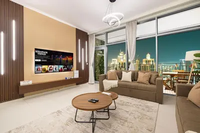 a living room with a couch and a tv at Spacious Lux 4 Bed with Large Balcony and Burj View by Vista Stays Dubai in Dubai