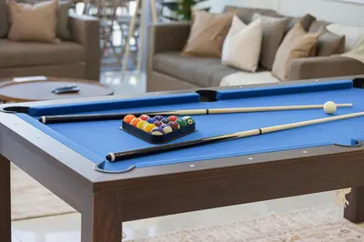 a pool table with four balls and cuesticks on it at Spacious Lux 4 Bed with Large Balcony and Burj View by Vista Stays Dubai in Dubai