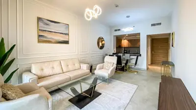 a living room with a couch and a table at 1BR Study luxury Furnished Utilities Included DXB in Dubai