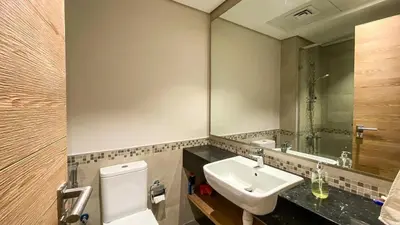 a bathroom with a sink and a mirror at 1BR Study luxury Furnished Utilities Included DXB in Dubai