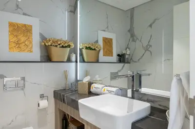 a white bathroom with a sink and a mirror at Vogue Dubai Hills The Pinnacle near Dubai Hills Mall and Park, One Bedroom Apartment with Large Balcony and City View, Access to all Amenities in Dubai