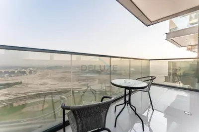 a table and chairs in a room with a window at Sky-High 2BR with City Views, Minutes Drive to Downtown, Steps from the Bus Stop, Nobles Tower, Business Bay by Deluxe Holiday Homes in Dubai