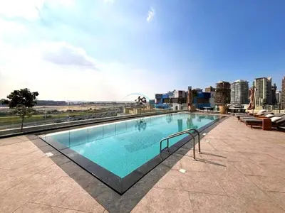 a large swimming pool on top of a building at Sky-High 2BR with City Views, Minutes Drive to Downtown, Steps from the Bus Stop, Nobles Tower, Business Bay by Deluxe Holiday Homes in Dubai