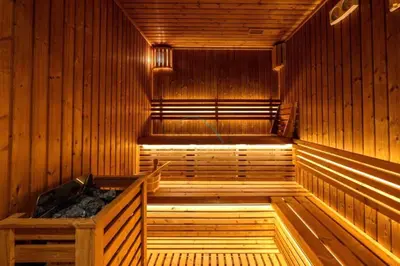 a wooden sauna with a hot tub in it at Sky-High 2BR with City Views, Minutes Drive to Downtown, Steps from the Bus Stop, Nobles Tower, Business Bay by Deluxe Holiday Homes in Dubai