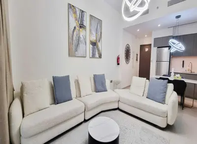 a living room with a white couch and blue pillows at Grande-5703,2 BHK Down Town, Dubai in Dubai