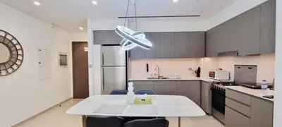 a kitchen with a white table in a room at Grande-5703,2 BHK Down Town, Dubai in Dubai
