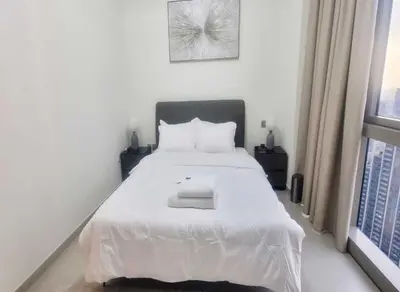 a white bed in a bedroom with a window at Grande-5703,2 BHK Down Town, Dubai in Dubai