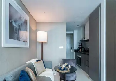 a living room with a couch and a table at Premium Living with Canal views and Top Notch Amenities in Dubai