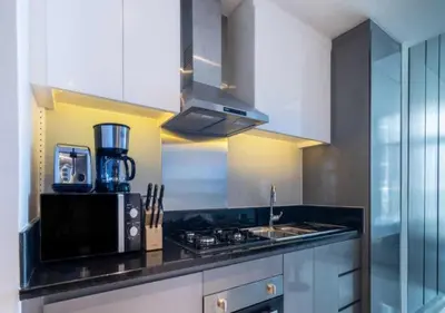 a kitchen with a sink and a stove top oven at Premium Living with Canal views and Top Notch Amenities in Dubai