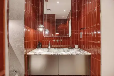 a bathroom with a sink and a mirror at Stylish Studio Loft with Outdoor Patio in JVC in Dubai