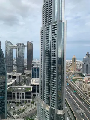 a view of a large skyscraper in a city at Kempinski Central Avenue Residence Largest 1BR with Burj Khalifa View in Dubai
