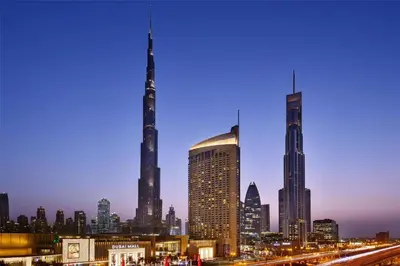 a view of a city at night with a skyline at Kempinski Central Avenue Residence Largest 1BR with Burj Khalifa View in Dubai