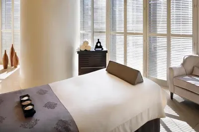 a bedroom with a large white bed with a box on it at Kempinski Central Avenue Residence Largest 1BR with Burj Khalifa View in Dubai