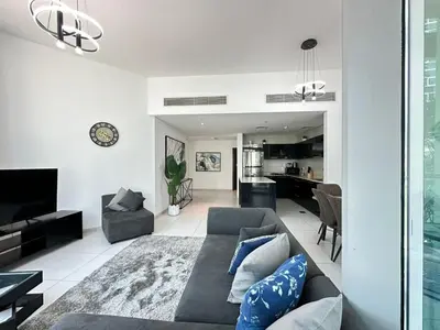 a living room with a couch and a tv at Modern 2 Bedroom Apartment in Dubai Marina in Dubai