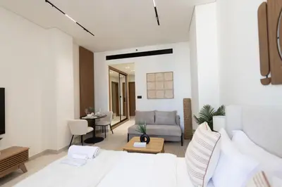 a bedroom with a bed and a living room at Luxury Studio - Private Jacuzzi & Burj Khalifa View in Dubai