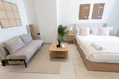 a living room with a bed and a couch at Luxury Studio - Private Jacuzzi & Burj Khalifa View in Dubai