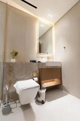 a bathroom with a toilet and a sink and a mirror at Luxury Studio - Private Jacuzzi & Burj Khalifa View in Dubai