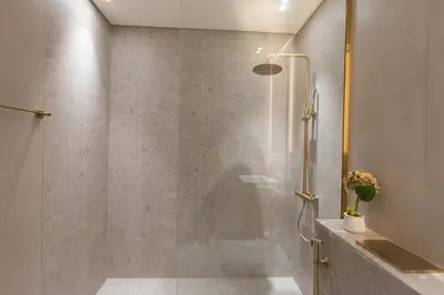 a shower with a glass door in a bathroom at Luxury Studio - Private Jacuzzi & Burj Khalifa View in Dubai