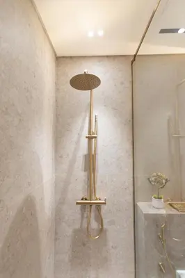 a bathroom with a shower with a sink and a shower at Luxury Studio - Private Jacuzzi & Burj Khalifa View in Dubai