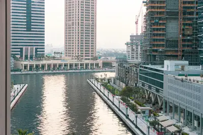 a river in the middle of a city with tall buildings at Brand New Building! 2 Double Bed! Ideal Location with 5-star Pool and Gym! in Dubai