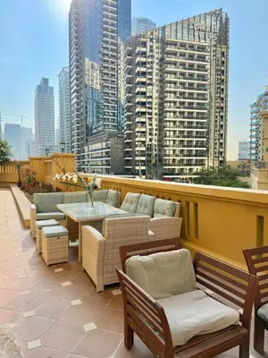 a patio with chairs and a table on a building at Smile Home Marina JBR Bed space in Dubai
