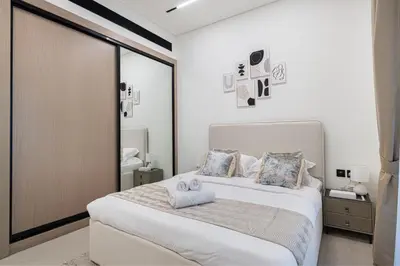 a bedroom with a bed with two towels on it at Elegant 2BR With Modern Design Near to Circle Mall in Dubai