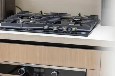 a black stove top sitting on top of a counter at Elegant 2BR With Modern Design Near to Circle Mall in Dubai