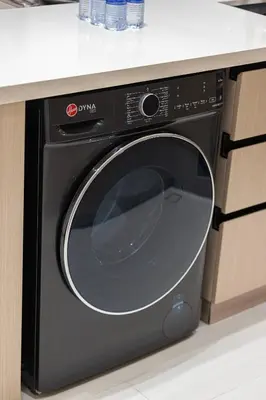 a black dishwasher in a kitchen under a counter at Elegant 2BR With Modern Design Near to Circle Mall in Dubai