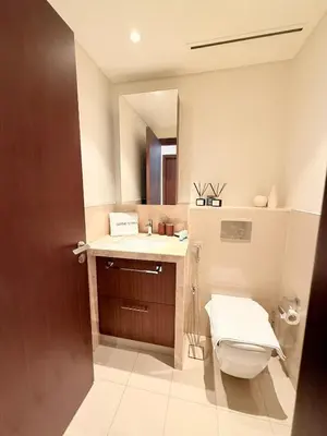 a bathroom with a toilet and a sink and a mirror at Dubai Mall connected, 38th floor, Amazing pool in Dubai