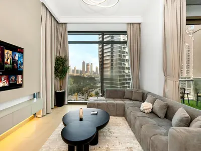 a living room with a couch and a table at Stunning 4BR Burj View Pool &Gym in Dubai