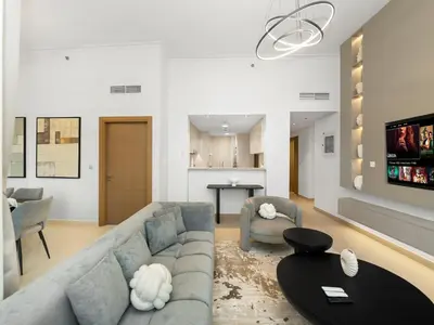 a living room with a couch and a table at Stunning 4BR Burj View Pool &Gym in Dubai