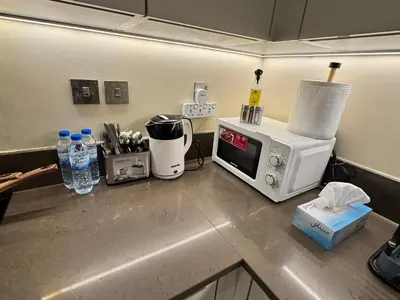 a kitchen counter with a microwave and a toaster oven at Free Infiniti Pool and Jacuzzi - Marina Gate Luxury Stay - Enjoy Dubai Marina Views in Dubai