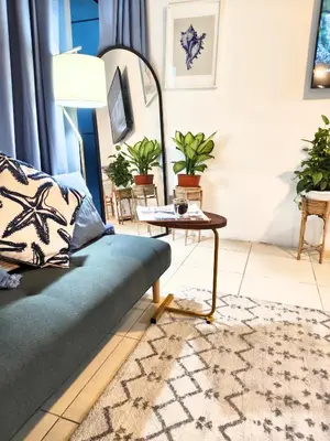 a living room with a couch and a table at Stylish JLT Apartment - Marina Skyline View - Next to Metro - Walk to Beach in Dubai
