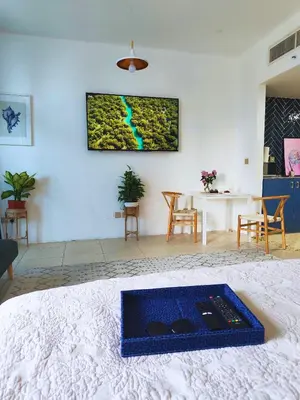 a living room with a tv on the wall at Stylish JLT Apartment - Marina Skyline View - Next to Metro - Walk to Beach in Dubai