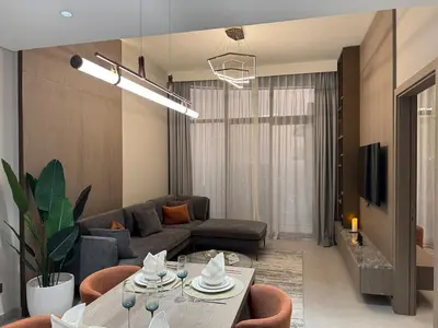 a living room with a couch and a table at Dubai corner at Westwood Imtiaz 1BR apartment in Dubai
