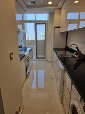 a kitchen with white appliances and a large window at شقة بالجي في سي Spacious apartment in Damac Ghalia JVC, Dubai in Dubai