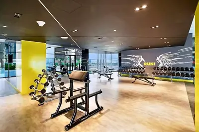 a gym with treadmills and exercise equipment in a building at Vogue Business Bay Aykon City Close to Downtown Burj Khalifa and Dubai Mall Burj Khalifa and Dubai Mall, One Bedroom Apartment with Balcony and City View, Access to all Amenities in Dubai