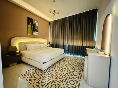 a bedroom with a bed and a television in it at Peaceful 1BR - Near DIFC & Trade Center and Downtown in Dubai