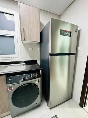 a kitchen with a stainless steel refrigerator and a microwave at Peaceful 1BR - Near DIFC & Trade Center and Downtown in Dubai