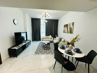 a living room with a table and a couch at Peaceful 1BR - Near DIFC & Trade Center and Downtown in Dubai