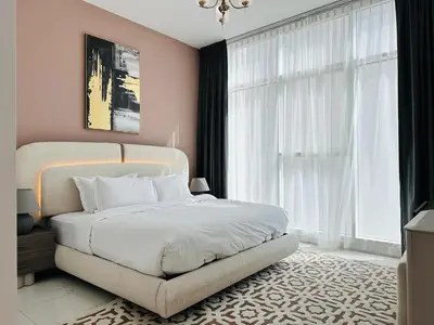 a bedroom with a white bed and a large window at Peaceful 1BR - Near DIFC & Trade Center and Downtown in Dubai