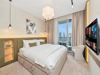 a bedroom with a large bed and a flat screen tv at 2 Bedroom Luxury Burj Khalifa & Fountain View Connected to Dubai Mall in Dubai